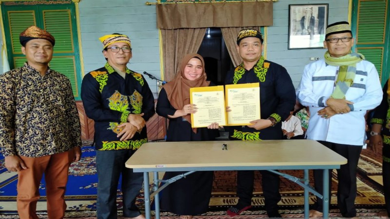 Kepala BPJS Ketenagakerjaan Cabang Tarakan Rina Umar (tengah) bersama pengurus Forum Komunikasi Ane' Belungon (FKAB) Provinsi Kalimantan Utara berfoto bersama usai penandatangan nota kesepahaman kerja sama pelindungan pekerja sosial di Situs Rumah Raya, Kecamatan Tanjung Palas, Kabupaten Bulungan, Jumat petang (28/10/2022). (ANTARA/Ayu Prameswari)