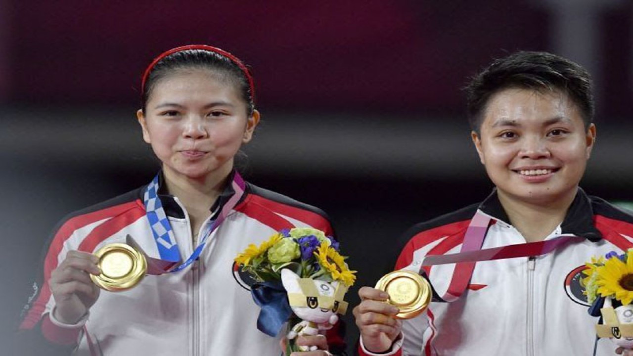 Arsip - Pebulutangkis ganda Putri Indonesia Greysia Polii (kiri) dan Apriyani Rahayu berpose bersama medali emas yang mereka raih untuk nomor bulu tangkis ganda putri Olimpiade Tokyo 2020, di Musashino Forest Sport Plaza, Tokyo, Jepang, Senin (2/8/2021). Dok ANTARA