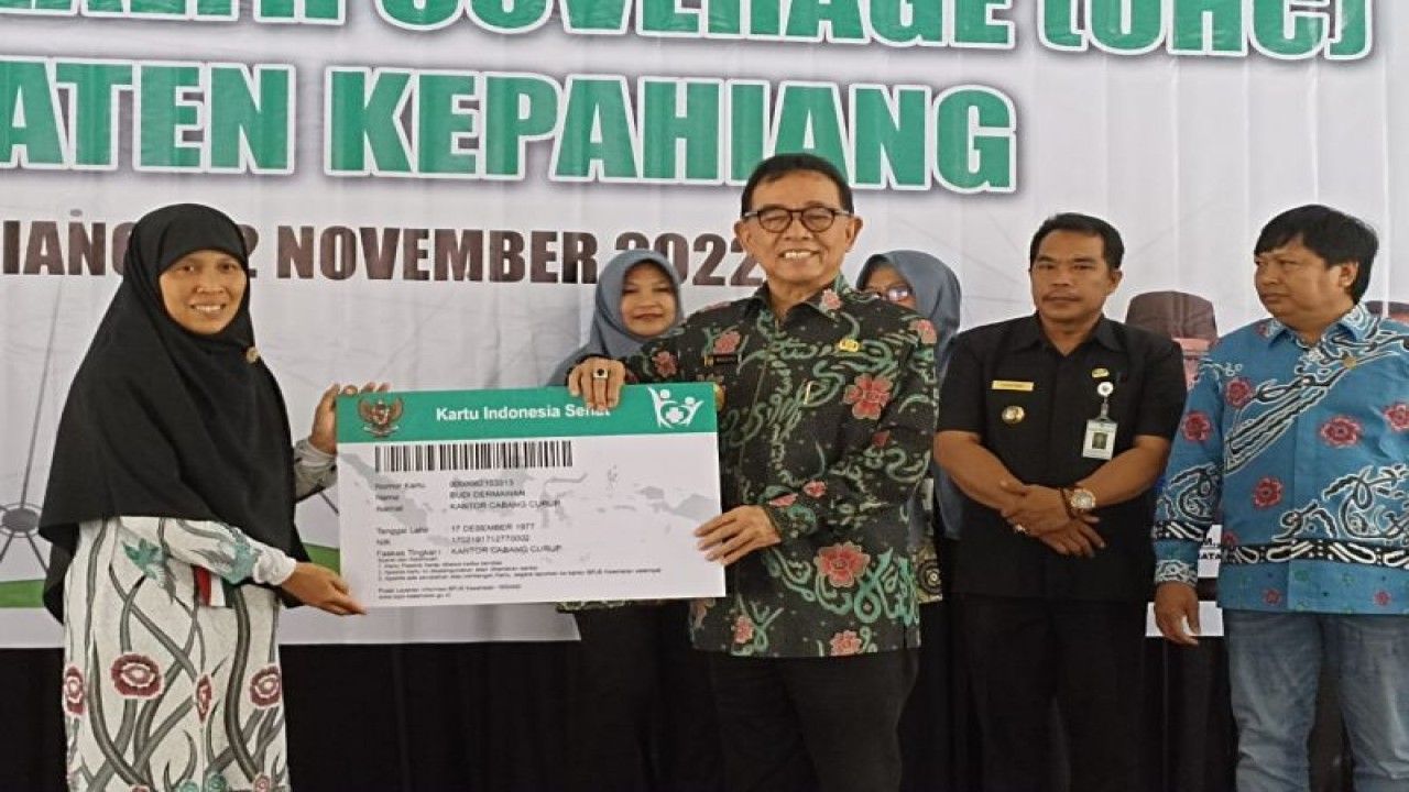 Bupati Kepahiang Hidayatullah Sjahid saat menyerahkan secara simbolis kartu peserta JKN-KIS kepada warga daerah itu baru-baru ini. ANTARA/HO-Diskominfo Kepahiang