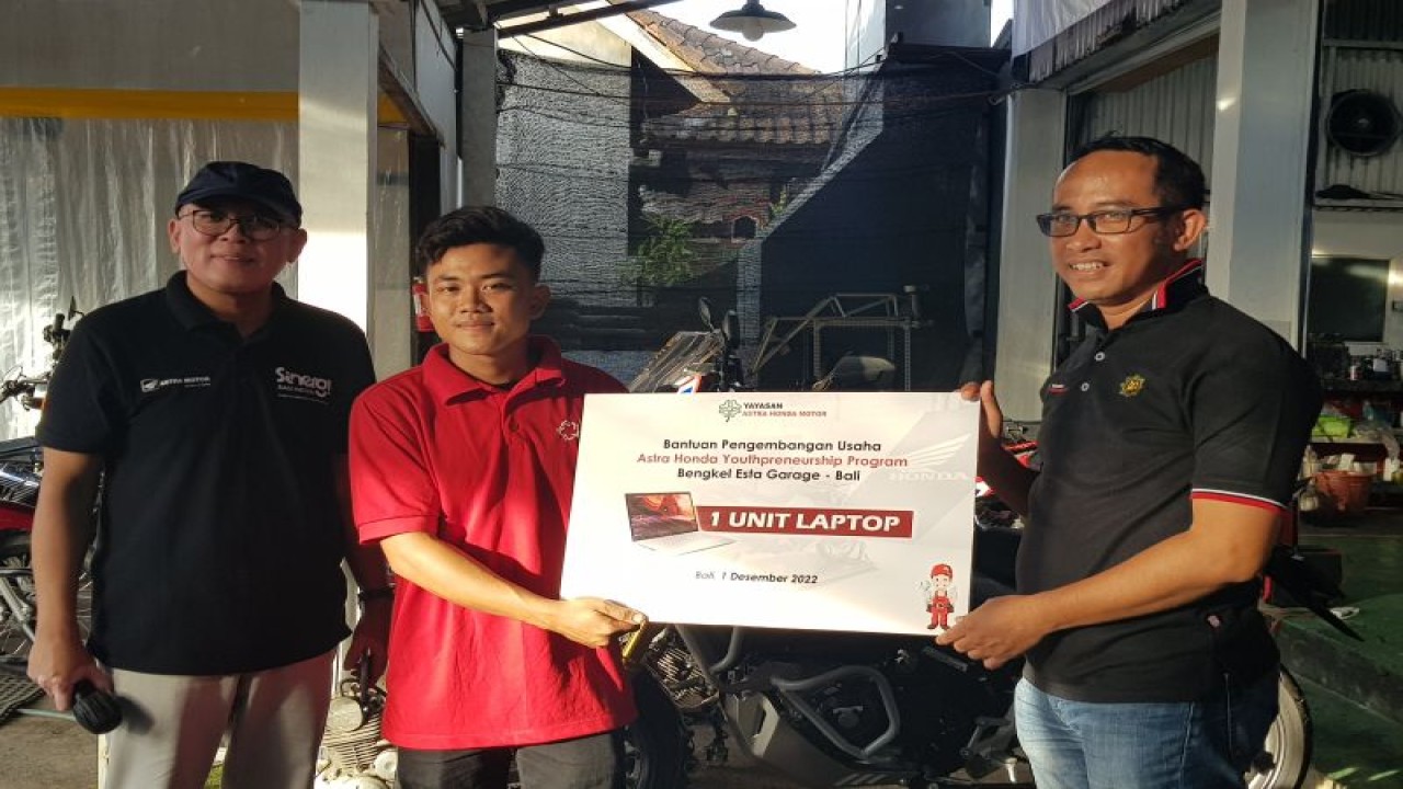 Ketua Yayasan AHM Ahmad Muhibbuddin (kanan) saat menyerahkan bantuan laptop untuk pemilik bengkel Esta Garage, Yoga Prasetyo (tengah), di dampingi Manager CSR AHM Agus Subagja (kiri), guna mendukung bisnis bengkel anak muda, di Canggu, Bali. (ANTARA/Risbiani Fardaniah)