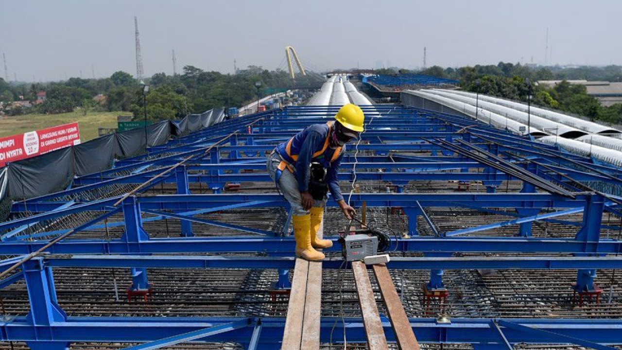 Pekerja beraktivitas di proyek pembangunan konstruksi jalan tol layang Jakarta-Cikampek (Japek) II di Bekasi, Jawa Barat. ANTARA FOTO/Sigid Kurniawan