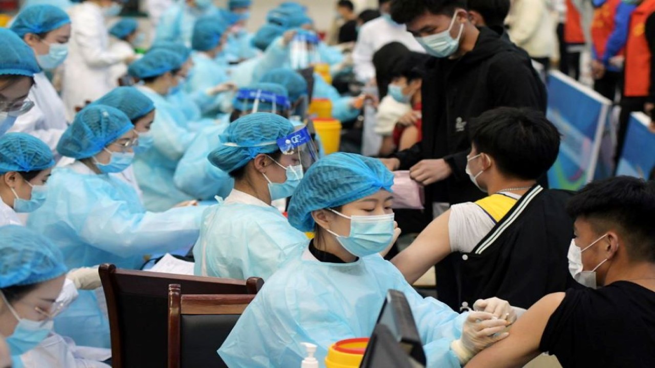 Petugas medis menyuntik mahasiswa dengan vaksin untuk melawan penyakit virus corona (Covid-19) di sebuah universitas di Qingdao, provinsi Shandong, China, 30 Maret 2021. (China Daily via Reuters)