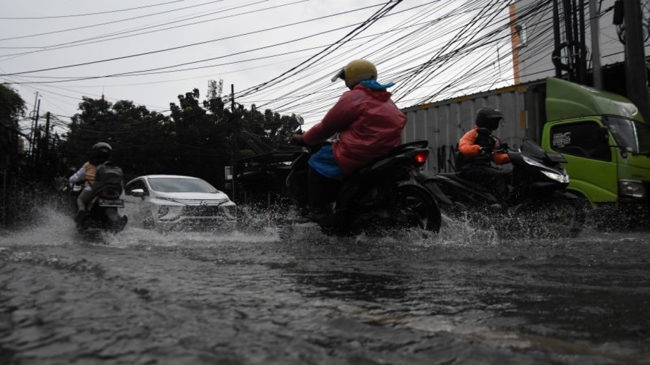 Pengendara kendaraan bermotor melintasi genangan banjir di kawasan Duren Tiga, Jakarta, Rabu (4/1/2023). ANTARA FOTO/Indrianto Eko Suwarso/hp.