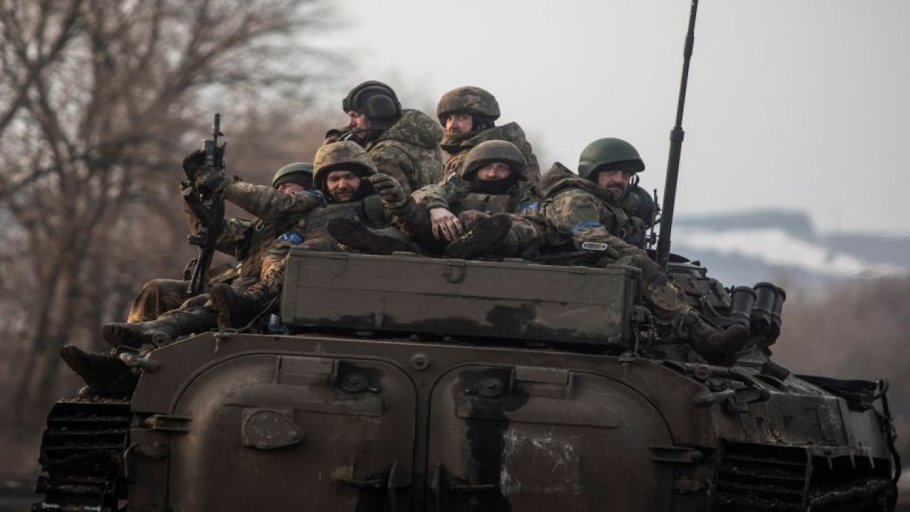 Tentara Ukraina menumpangi kendaraan tempur infantri BMP-2 yang berpacu di atas sebuah jalan di luar kota  Bakhmut, di tengah serangan Rusia di Ukraina, di Donetsk, Ukraina, pada 11 Februari 2023. (REUTERS/STRINGER)