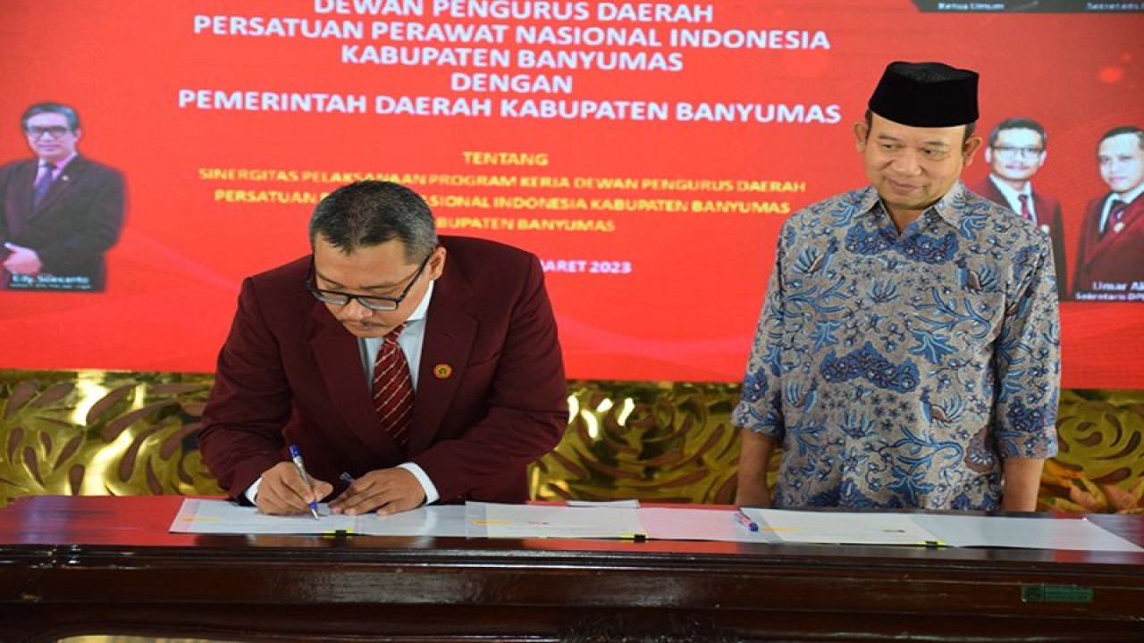Ketua DPD PPNI Kabupaten Banyumas Ns Asep Iskandar (kiri) dan Bupati Banyumas Achmad Husein menandatangani kesepakatan kerja sama di Pendopo Sipanji Purwokerto, Kabuaten Banyumas, Jumat (31/3/2023). ANTARA/HO-Setda Banyumas