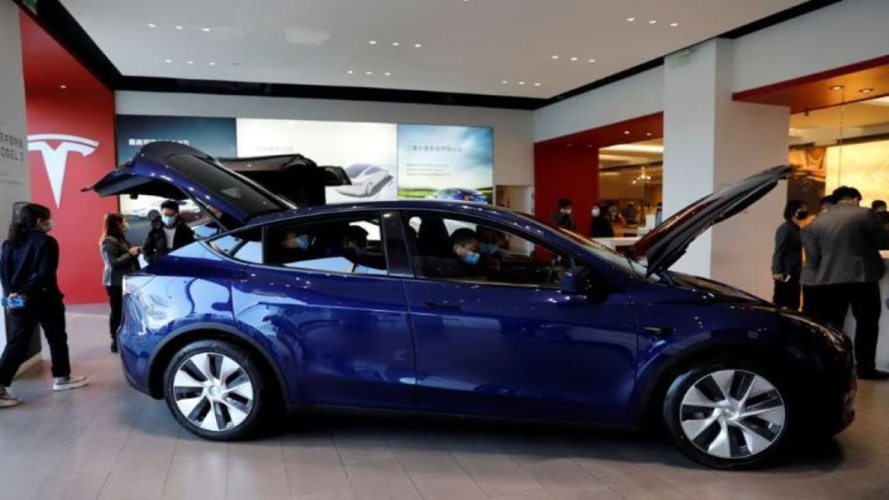 Pengunjung menyaksikan Tesla Model Y buatan China di showroom pembuat kendaraan listrik itu di Beijing, China 5 Januari 2021. (Tingshu Wang/Reuters)