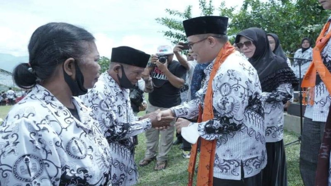 Arsip Foto. Wakil Bupati Sigi Samuel Yansen Pongi (kanan) berjabat tangan dengan para guru pada peringatan HUT PGRI Tingkat Kabupaten Sigi Tahun 2022 di Desa Wayu, Kecamatan Marawola Barat, Kamis (24/11/2022). (ANTARA/HO-Prokopim Setda Pemkab Sigi)