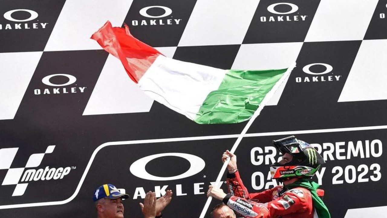 Pebalap tim Ducati Lenovo Francesco Bagnaia mengibarkan bendera saat menjuarai GP Italia di Mugello Circuit, Scarperia e San Piero, Italia, Minggu (11/6/2023). ANTARA FOTO/REUTERS/Jennifer Lorenzini/foc.