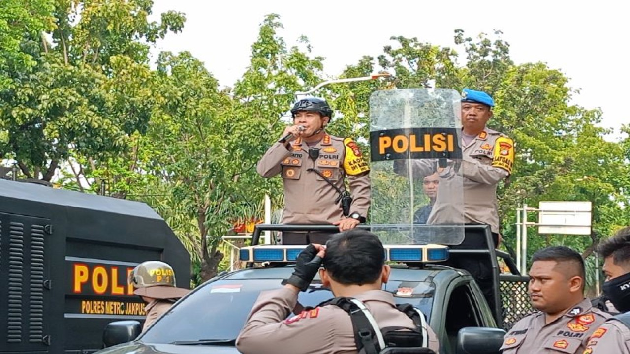 Kapolres Metro Jakarta Pusat Kombes Polisi Susatyo Purnomo Condro sambil berhadapan dengan massa di Jalan Medan Merdeka Selatan, Jakarta Pusat, Selasa (21/11/2023). (ANTARA/Siti Nurhaliza)