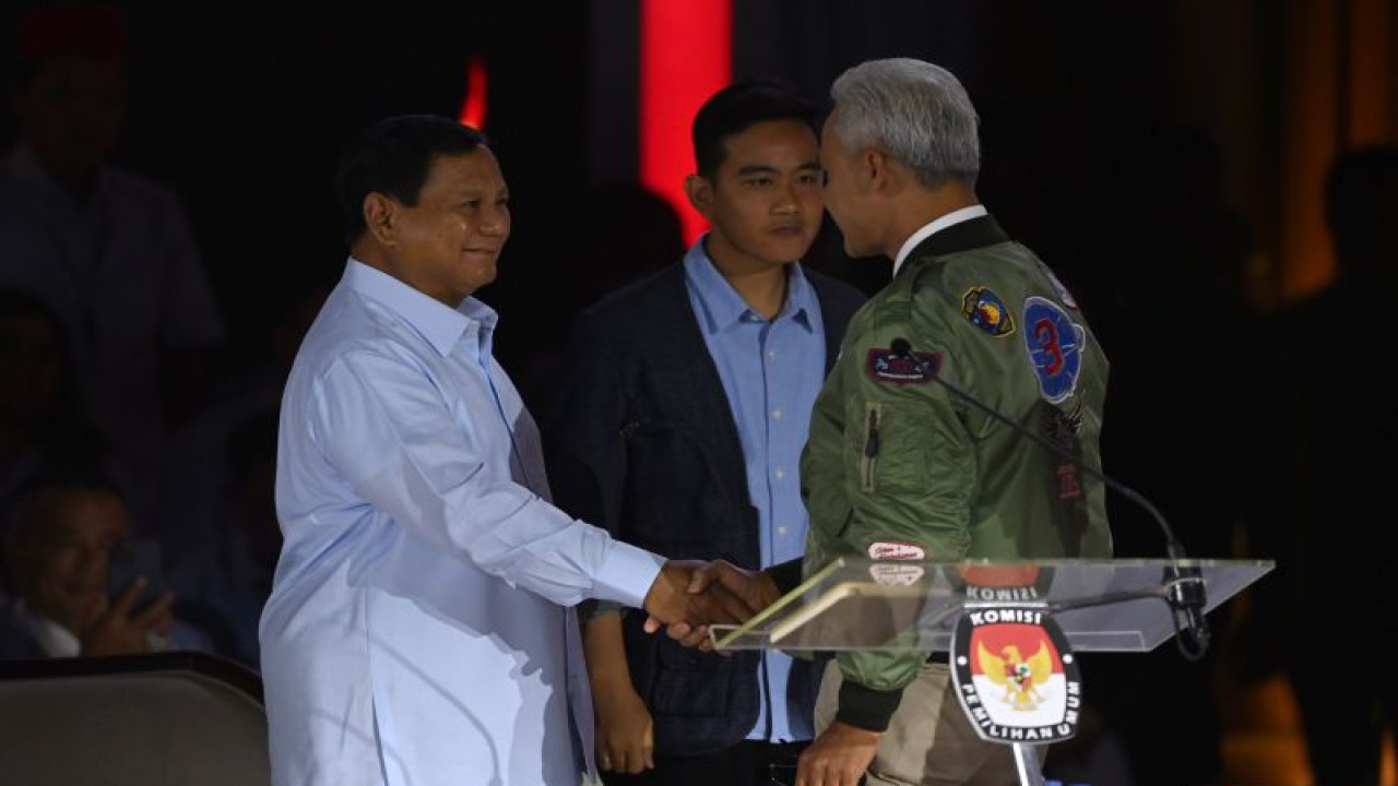 Capres nomor urut tiga Ganjar Pranowo (kanan) menyalami capres nomor urut dua Prabowo Subianto usai tiba di lokasi debat ketiga Pilpres 2024 di Istora Senayan, Jakarta, Minggu (7/1/2024) malam. ANTARA FOTO/Aditya Pradana Putra/foc.