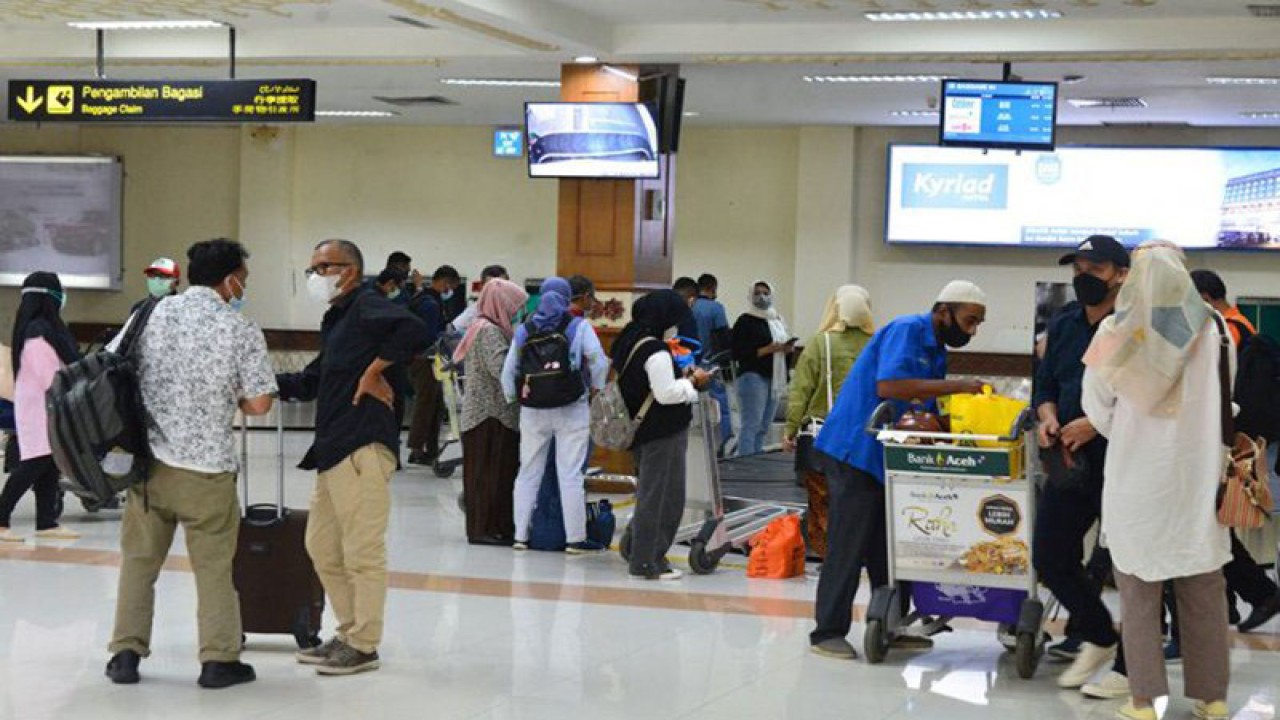 Penumpang pesawat Garuda Indonesia berada dalam ruangan kedatangan domestik setibanya di Bandara Internasional Sultan Iskandar Muda (SIM) Blang Bintang, Kabupaten Aceh Besar, Aceh, Sabtu (22/5/2021). ANTARA/Ampelsa